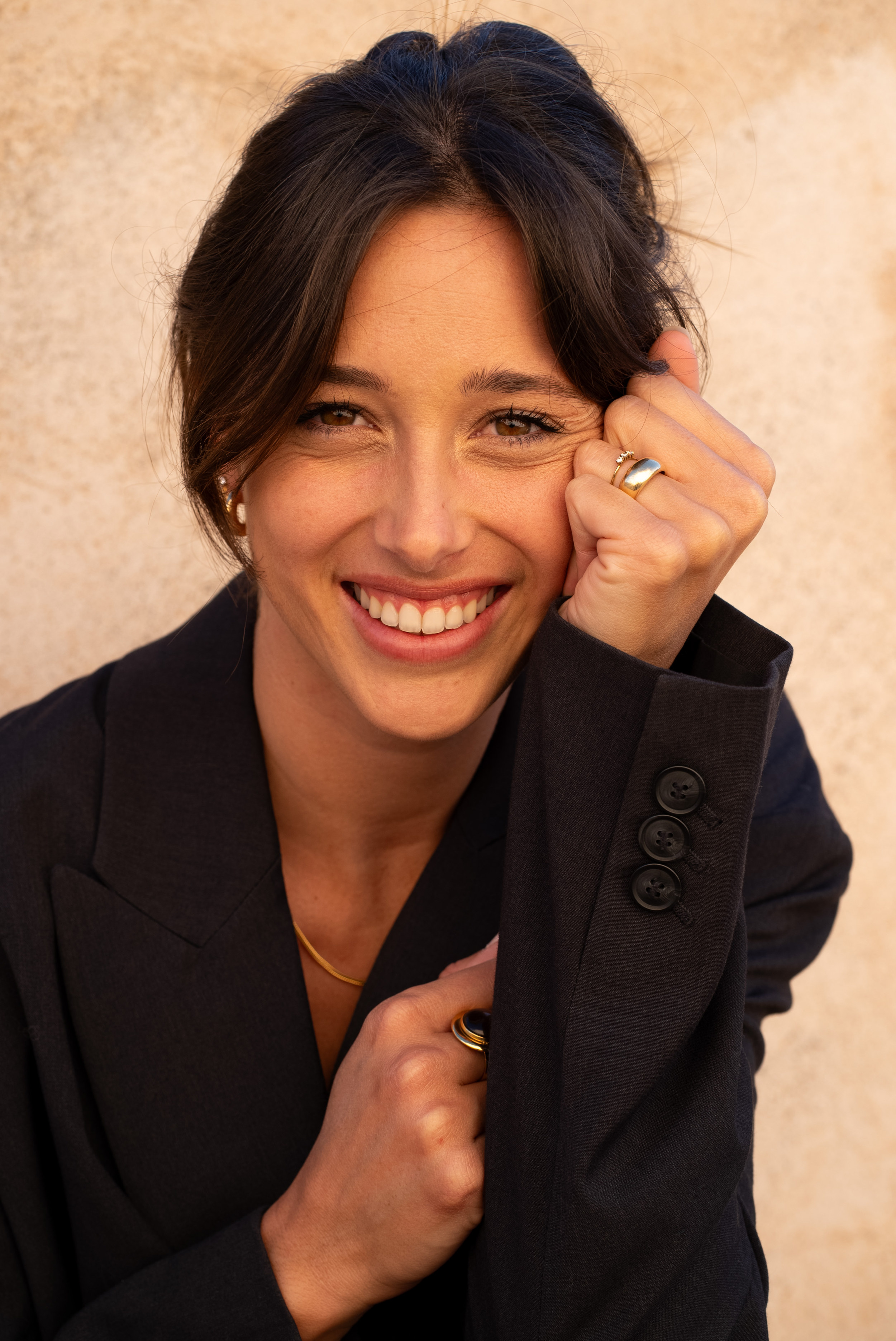 Portrait beauté d’une femme souriante en lumière dorée de fin de journée avec maquillage naturel.